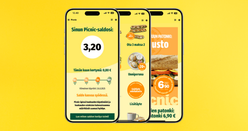 Picnic-ketjun uudistettu kanta-asiakassovellus ja sen keltaiset etunäkymät älypuhelimen näytöllä esittelemässä uutta kanta-asiakasohjelmaa.